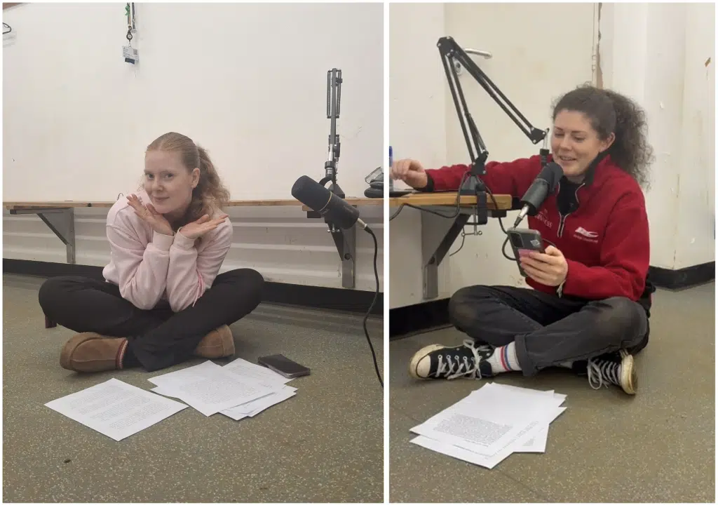 Podcast hosts Kal and Erin sat on the floor in a rugby changing room with their recording equipment